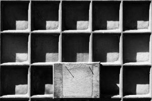 A series of square wooden boxes with a rectangular board over part