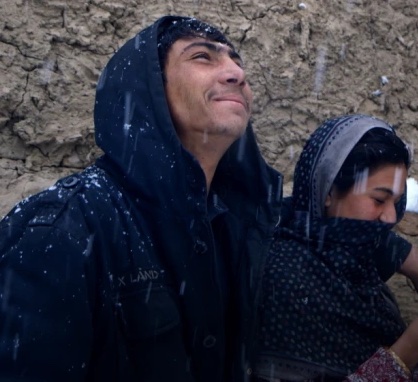 Shaista looking up at snow in sky