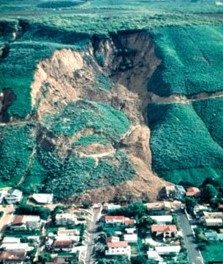 Aerial photo of a hill collapsing onto houses below.