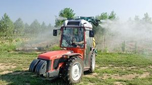 Photo of a tractor engulfed in white cloud