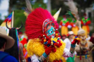 A Person wearing a mask during a festival in Colombia.