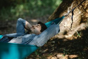 Person staking a nap in a hammock.